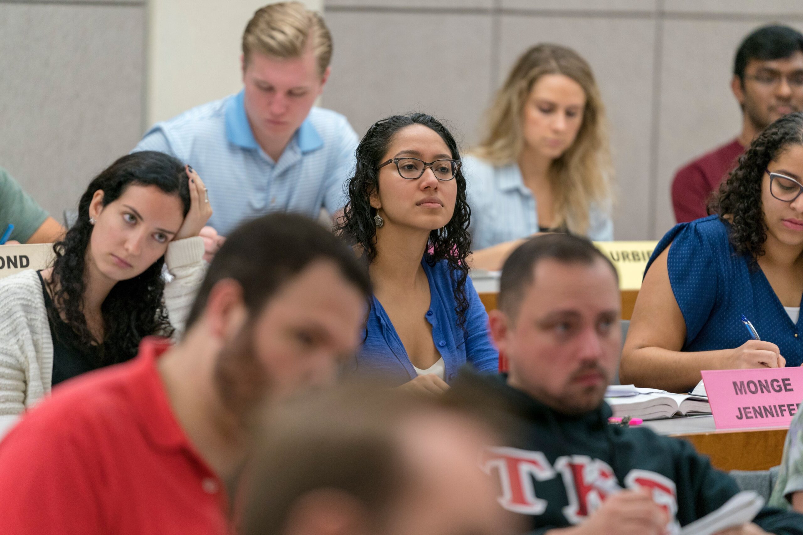 Student sitting in rows, some taking notes